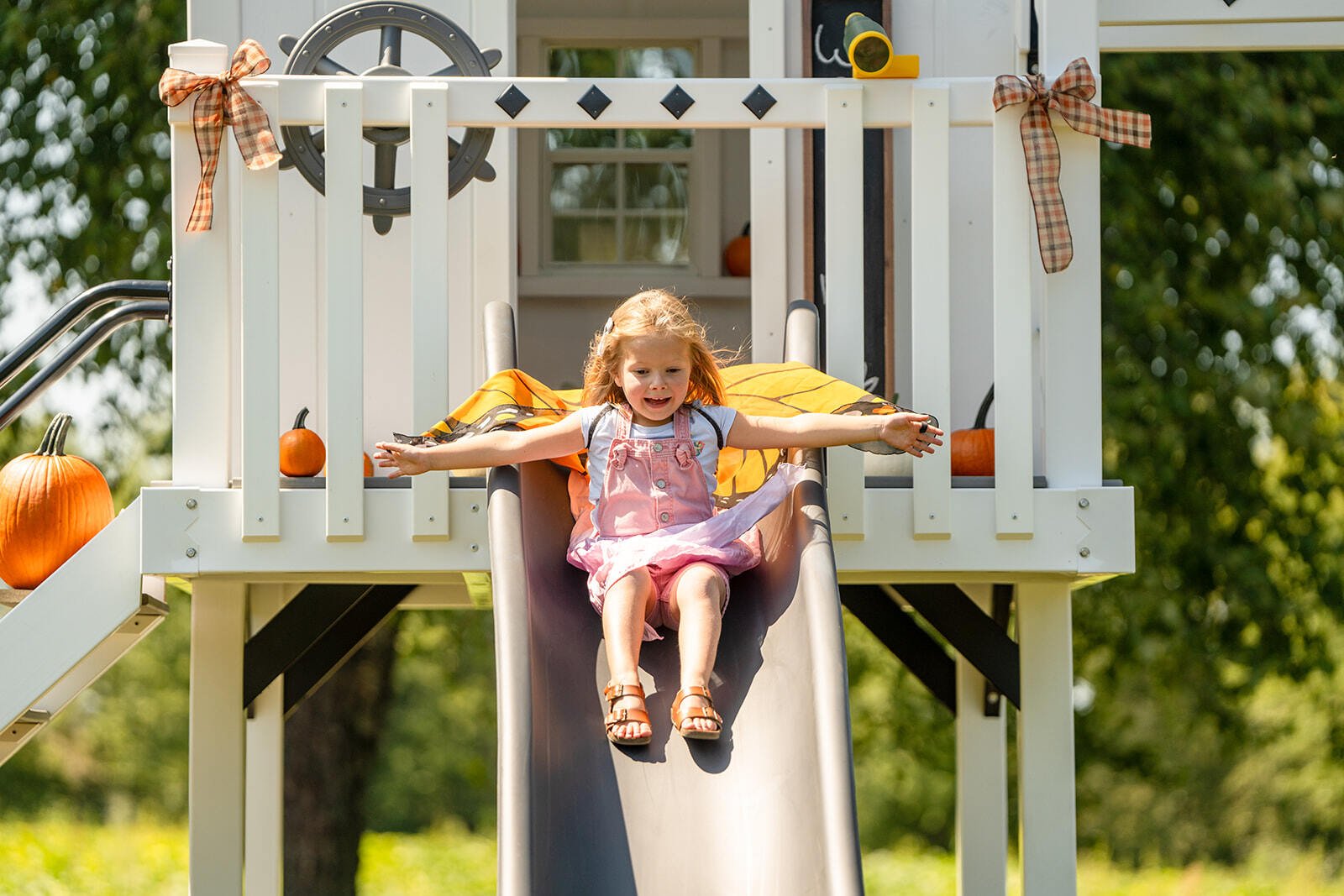 girl on slide on playset